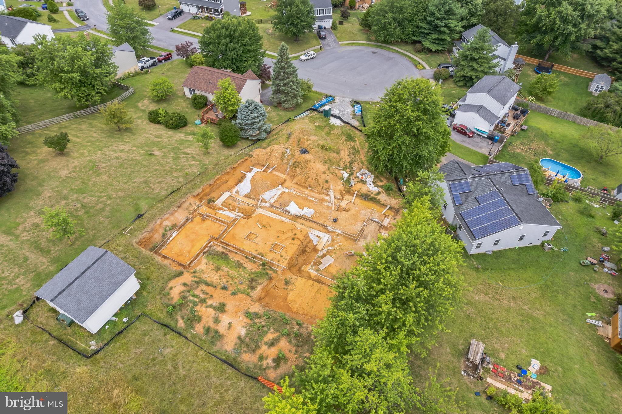 an aerial view of residential house with an outdoor space and seating area