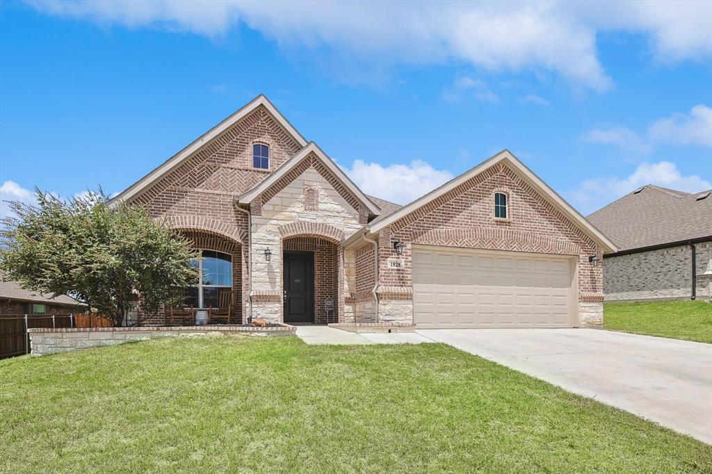 a front view of a house with a yard and garage