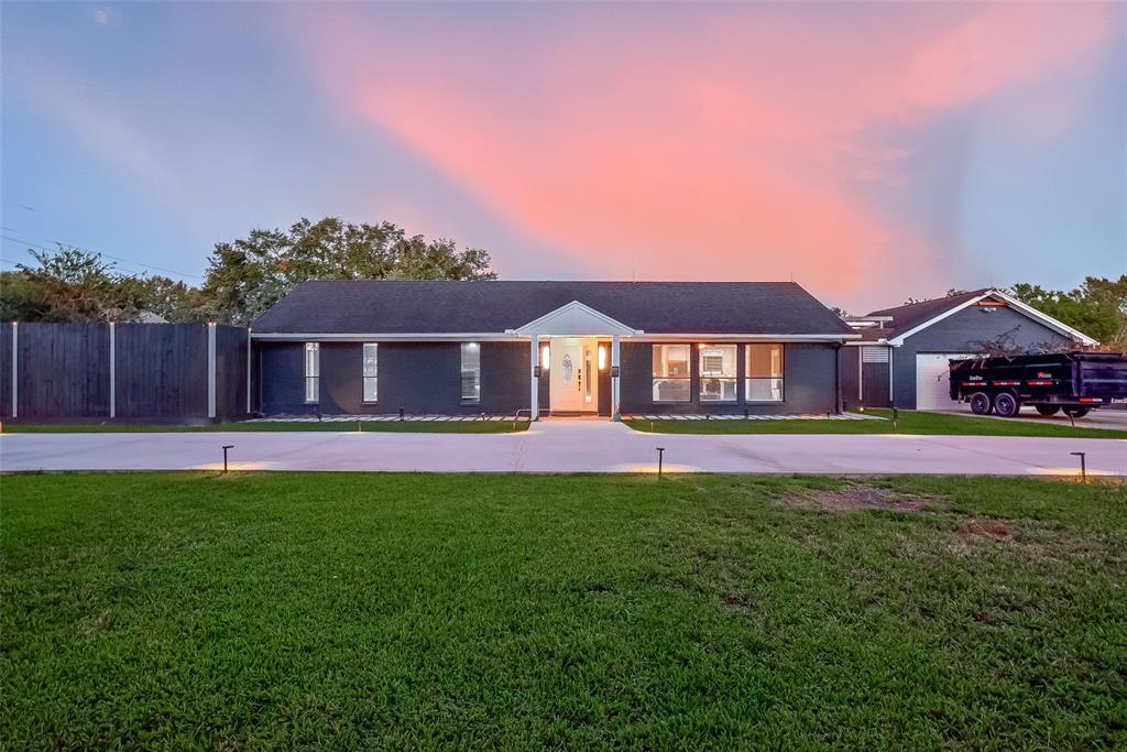 a front view of house with yard and outdoor seating