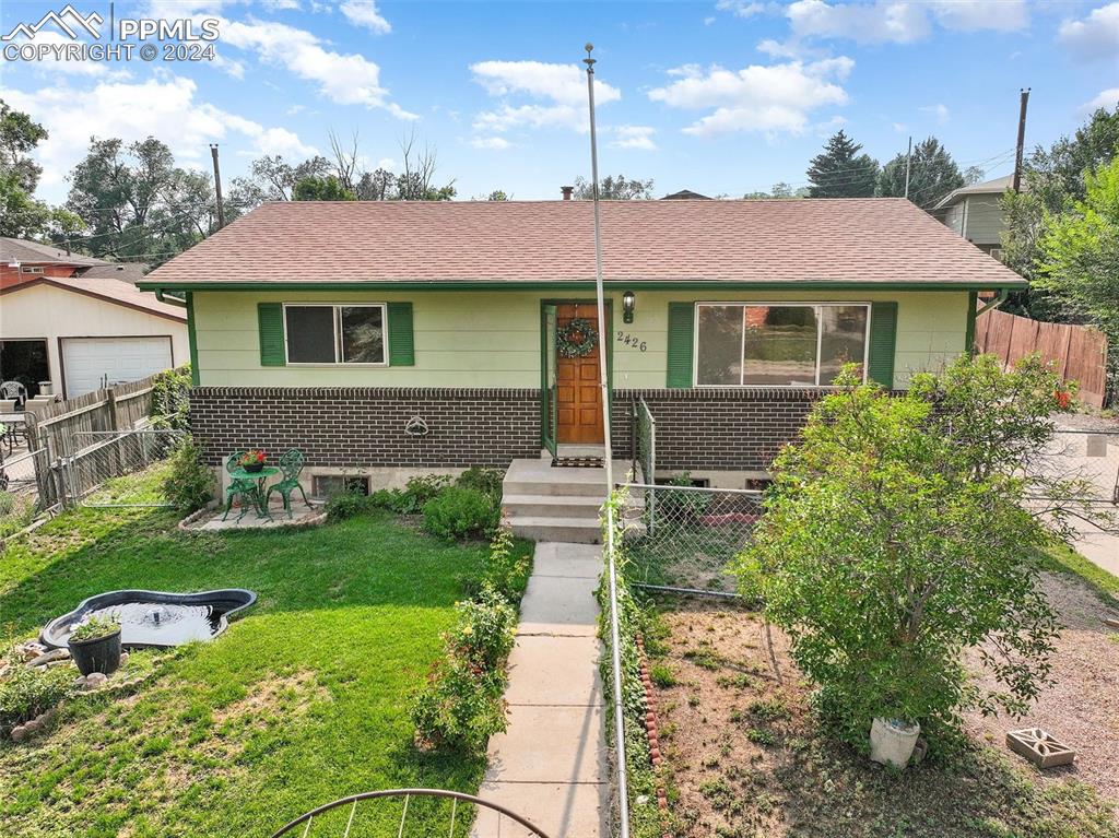 a front view of a house with a yard