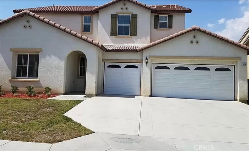 a front view of a house with garage