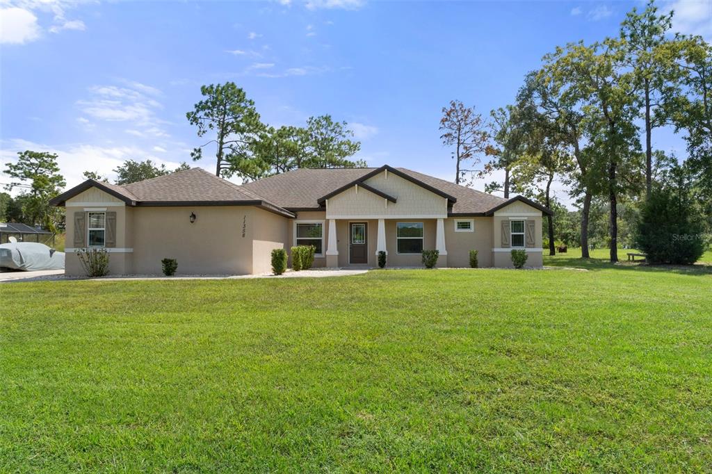 a view of a house with a yard and garage