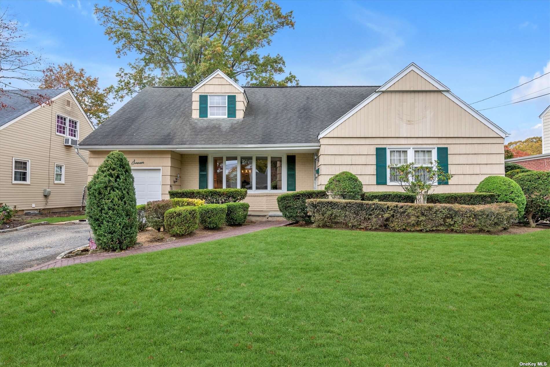 a front view of a house with a garden