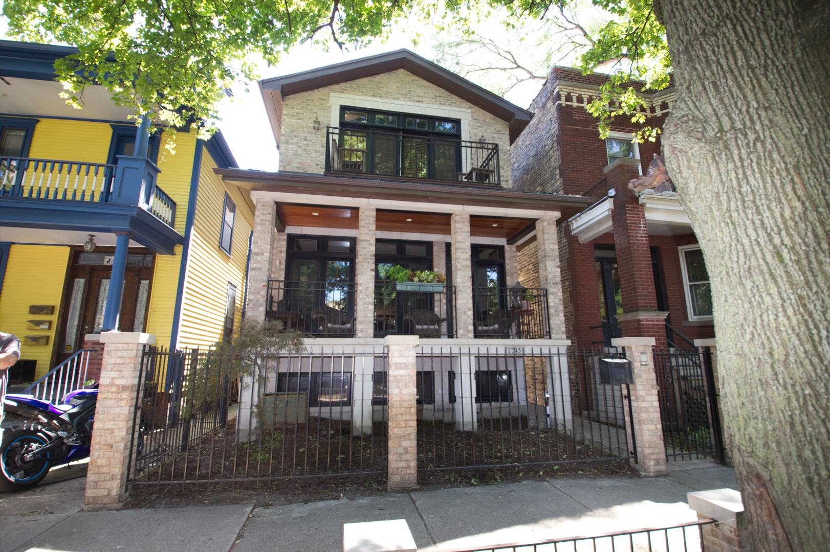 a view of a brick house with many windows