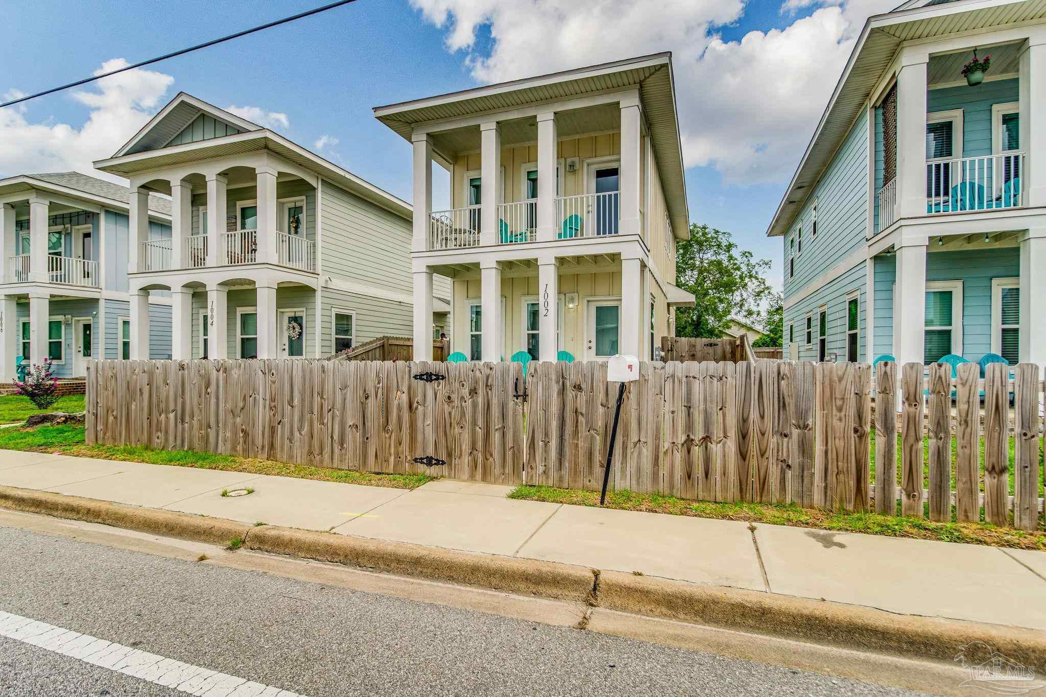 a front view of a house with a fence