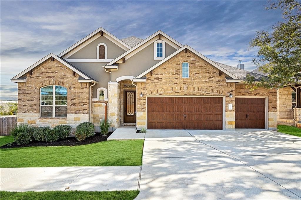 a front view of a house with a yard and garage