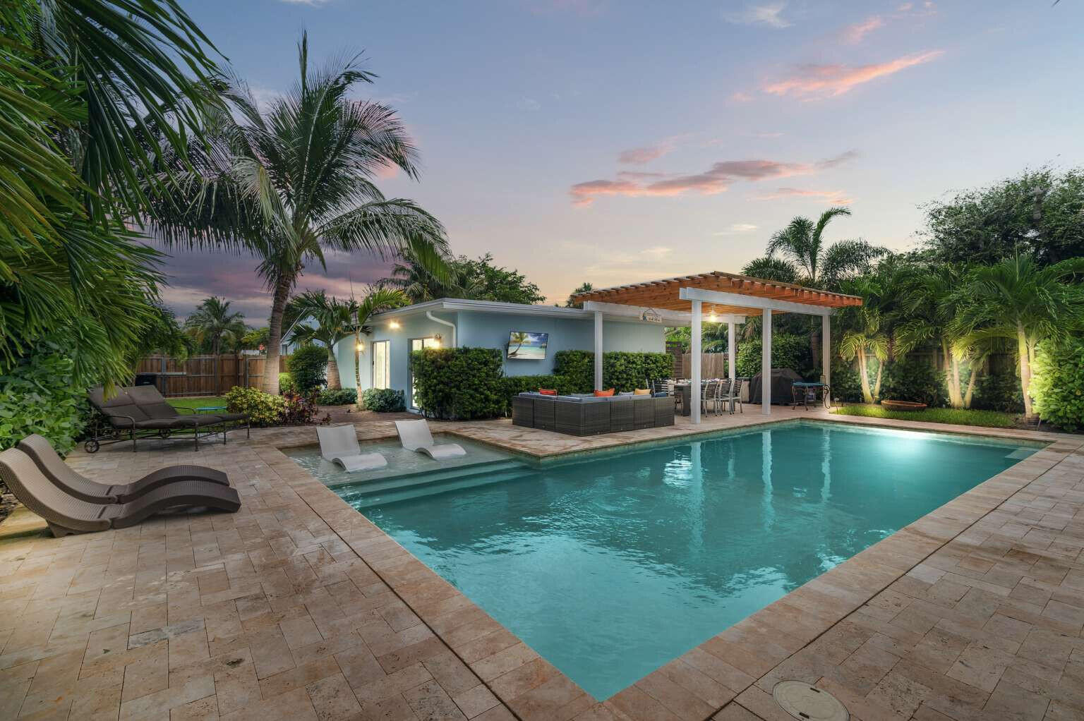 a view of a patio with swimming pool table and chairs