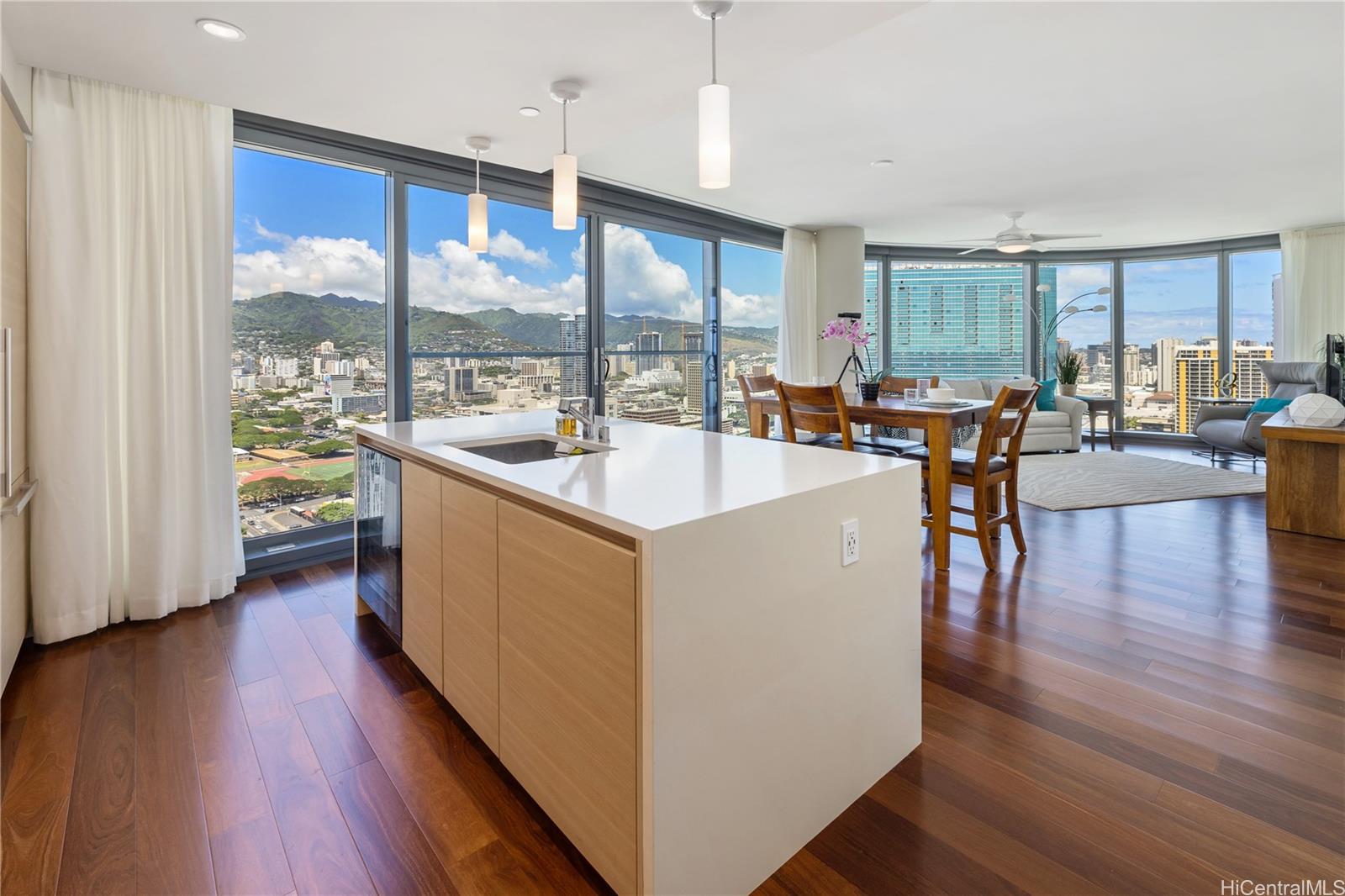 a kitchen with counter top space and wooden floor