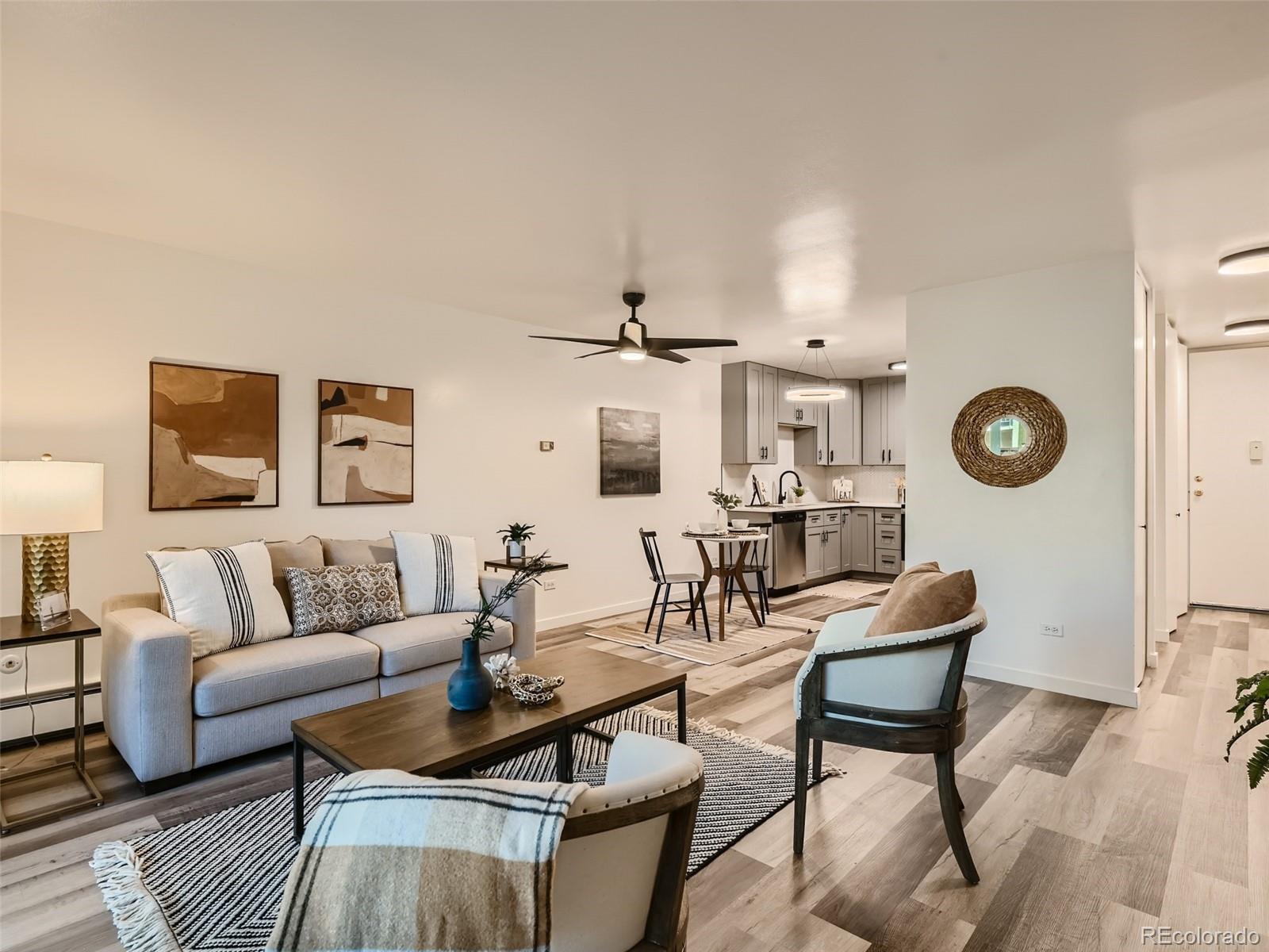 a living room with furniture and a wooden floor