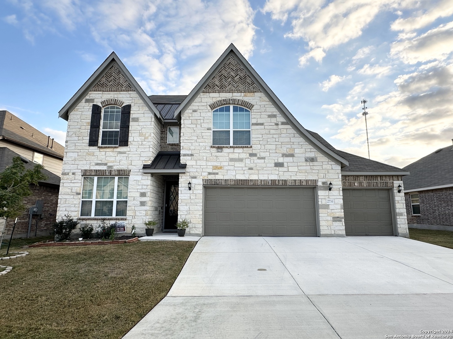 a front view of a house with a yard and garage