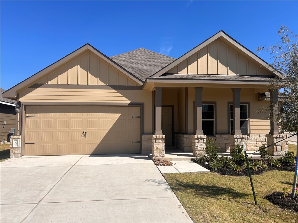 View of front of property with a porch, a front ya