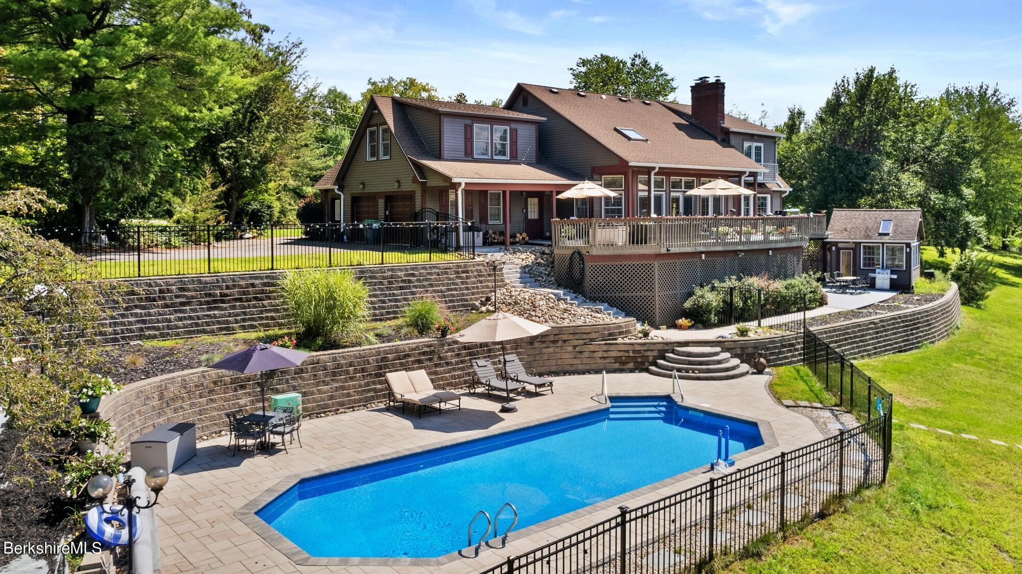 a view of a house with swimming pool and sitting area