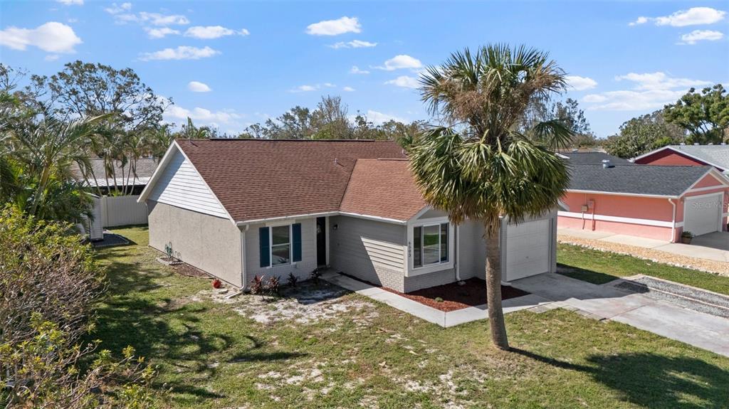 a view of a house with a yard and plant