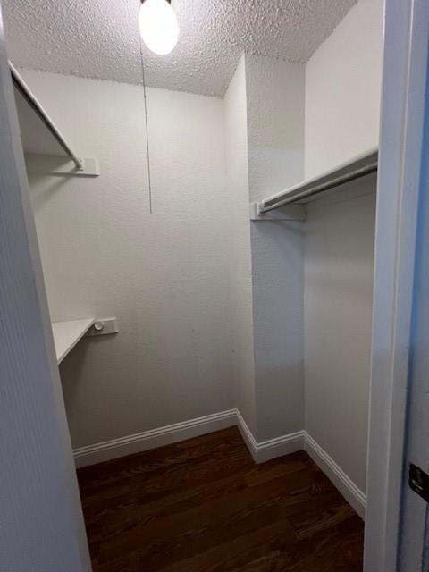 a view of a small space with wooden floor and closet