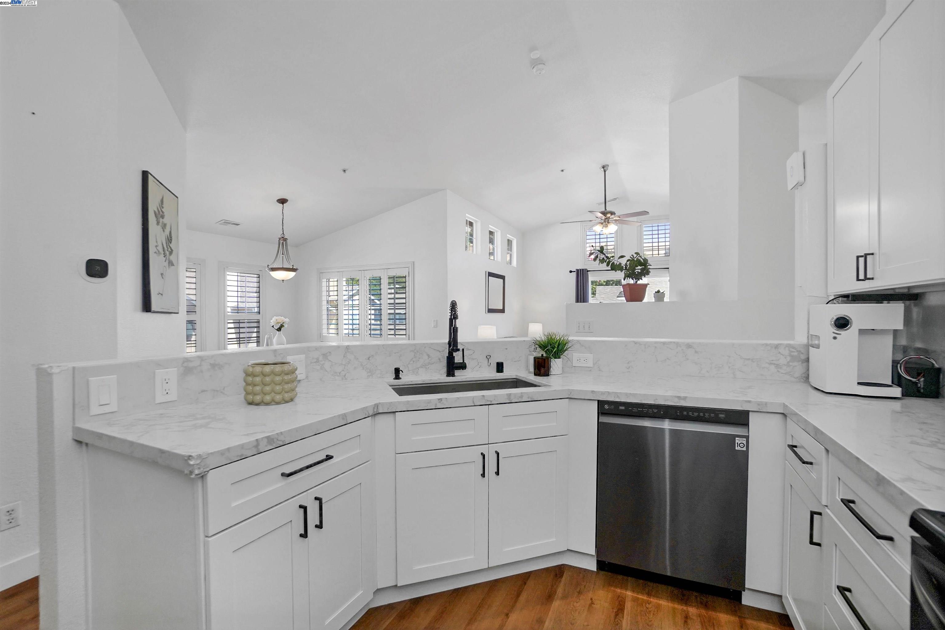 a kitchen with a sink dishwasher and cabinets