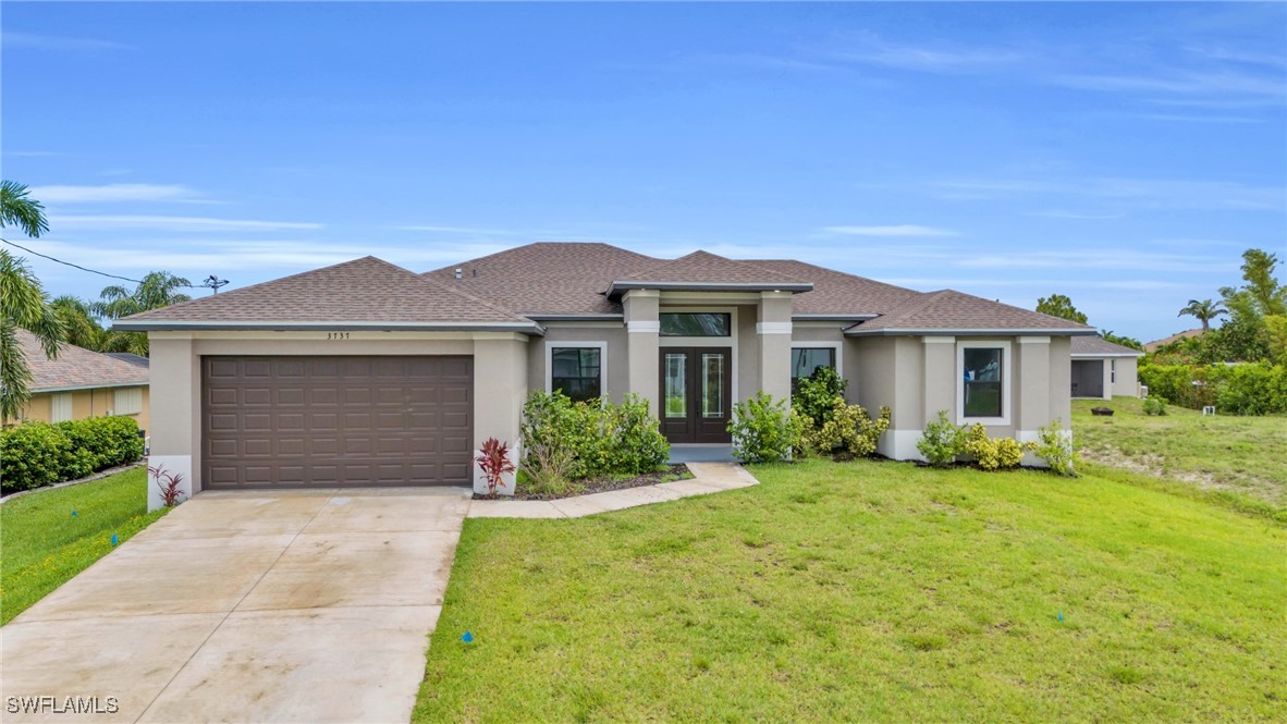 a front view of a house with a yard and garage