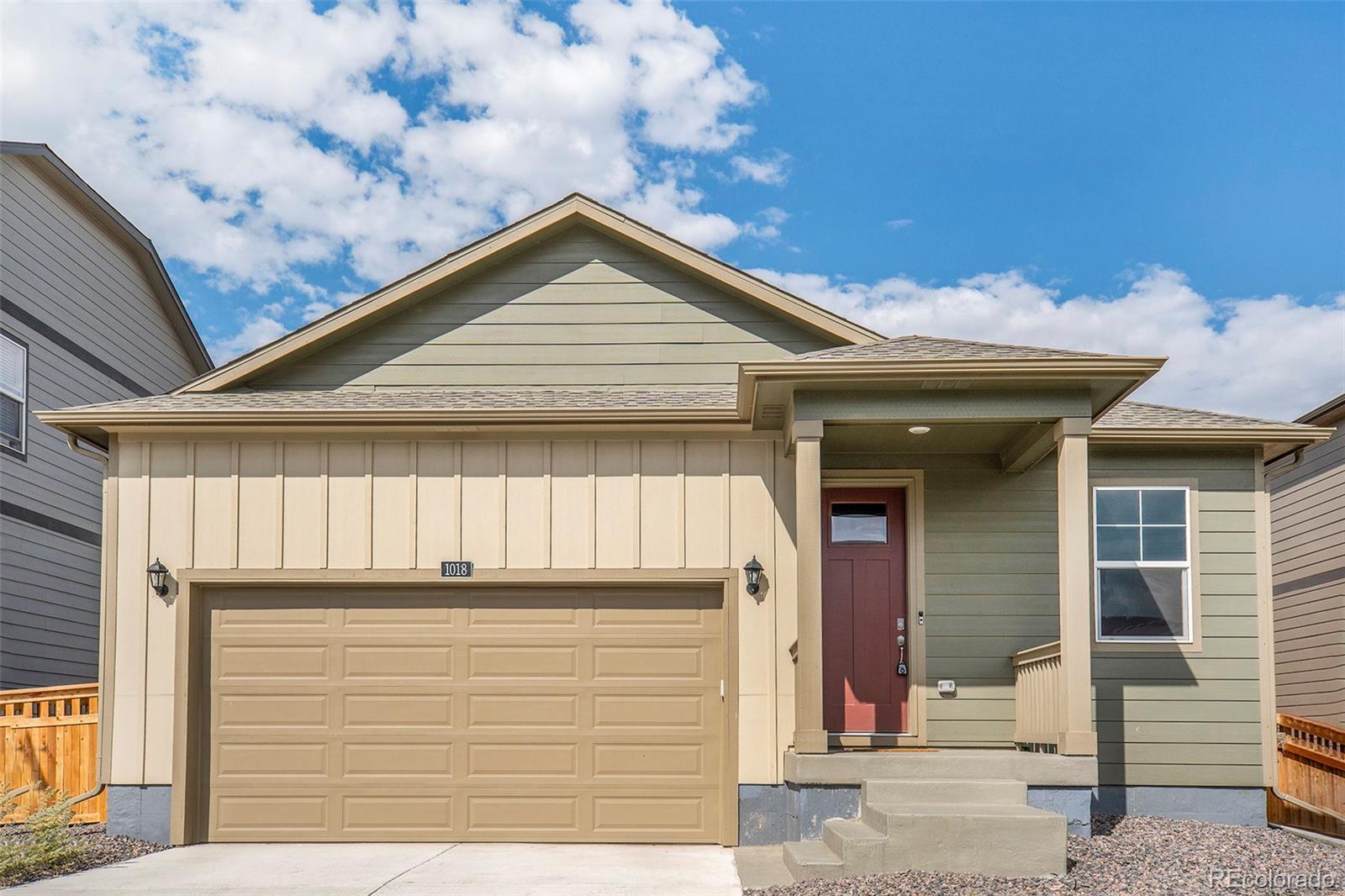 a front view of a house with garage