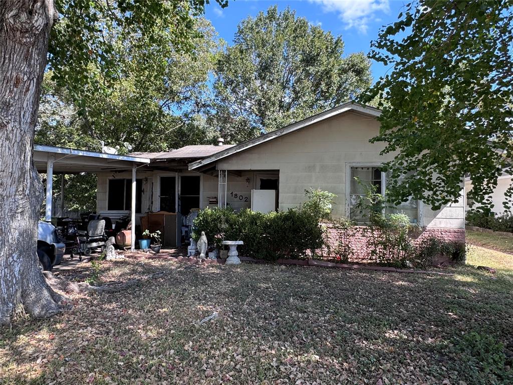 a view of a house with sitting area and garden