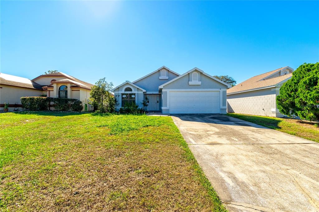 a front view of house with yard and green space