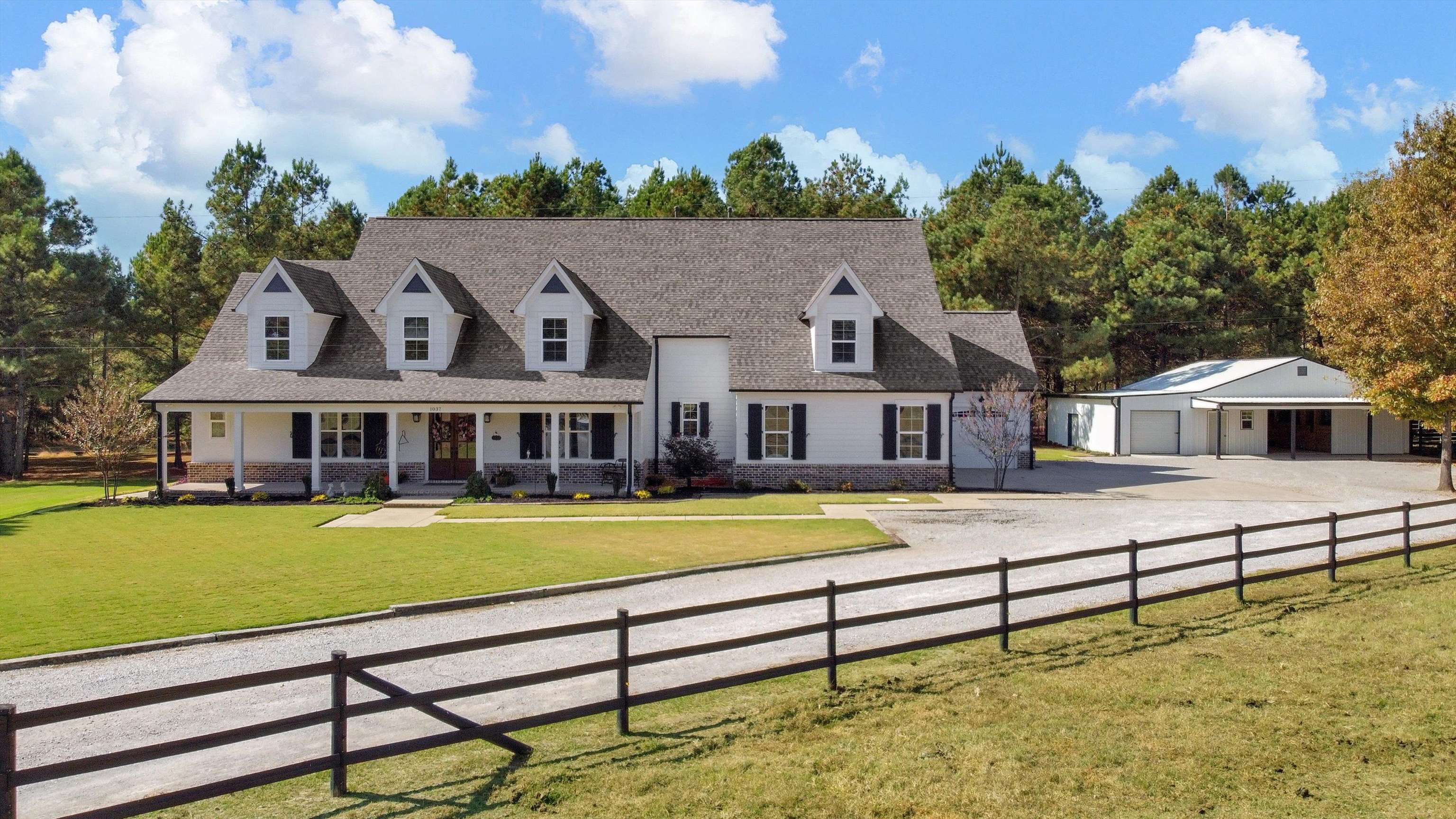 View of front facade with a porch, a garage, and a front yard