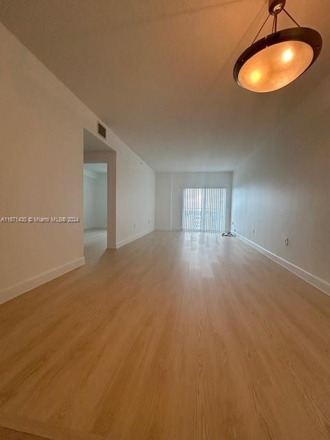 a view of an empty room and a window