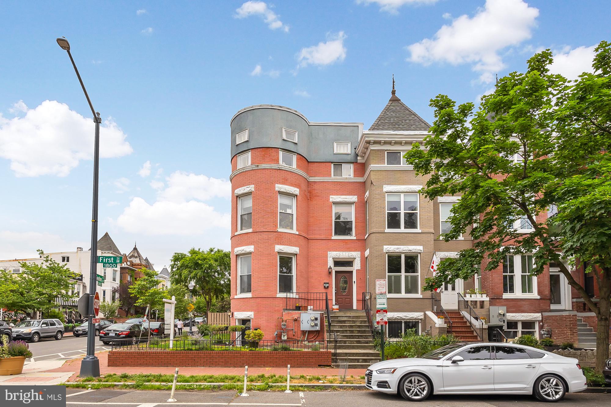 a front view of a residential apartment building with a yard