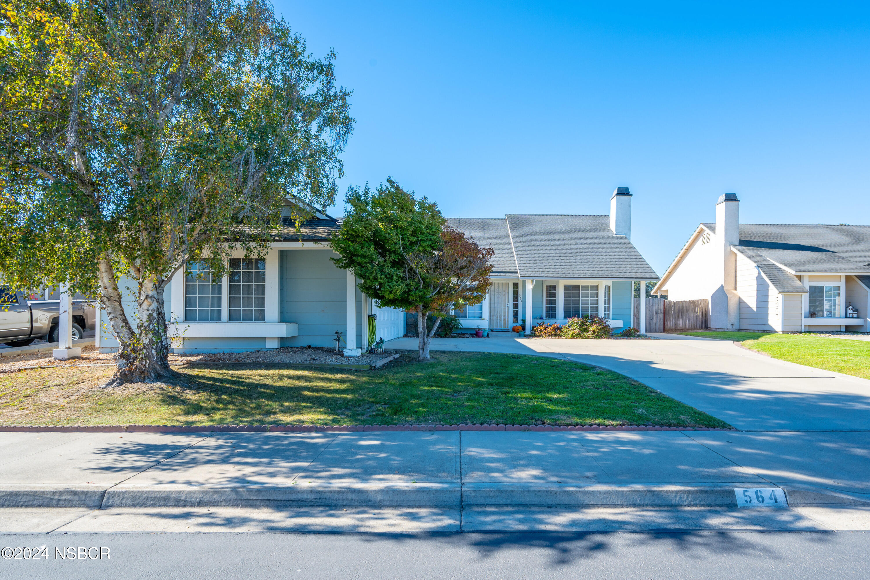 a front view of a house with yard and porch