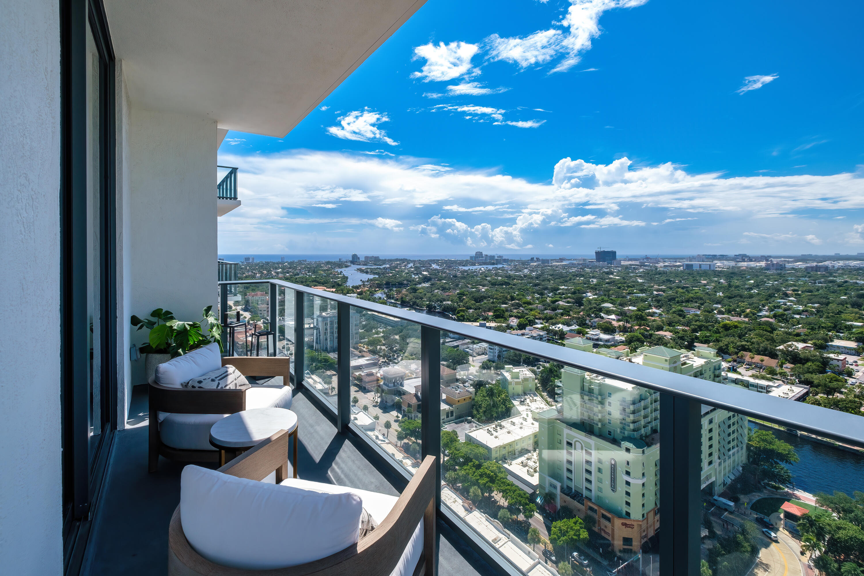 a view of a balcony with couches and wooden floor