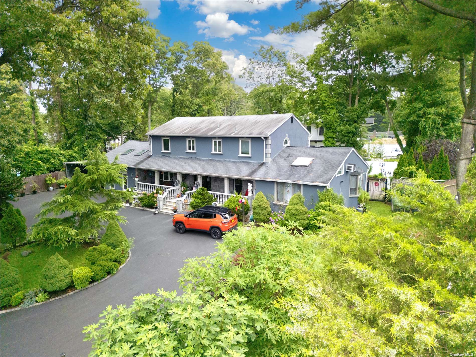 an aerial view of a house with garden space and sitting area