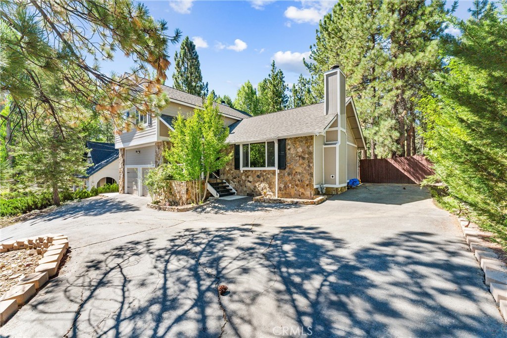 a view of a house with a tree in front of it