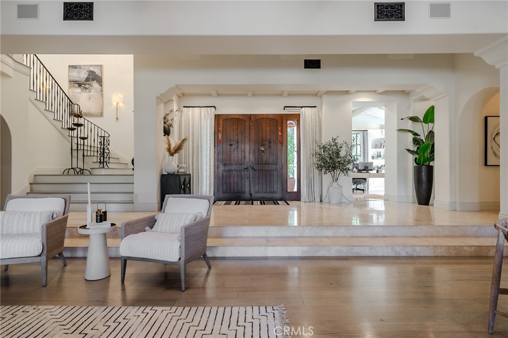 a view of a livingroom and dining room with wooden floor