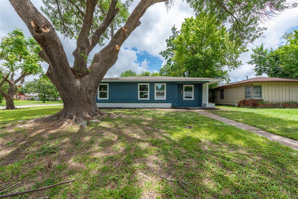 a front view of house with yard and green space