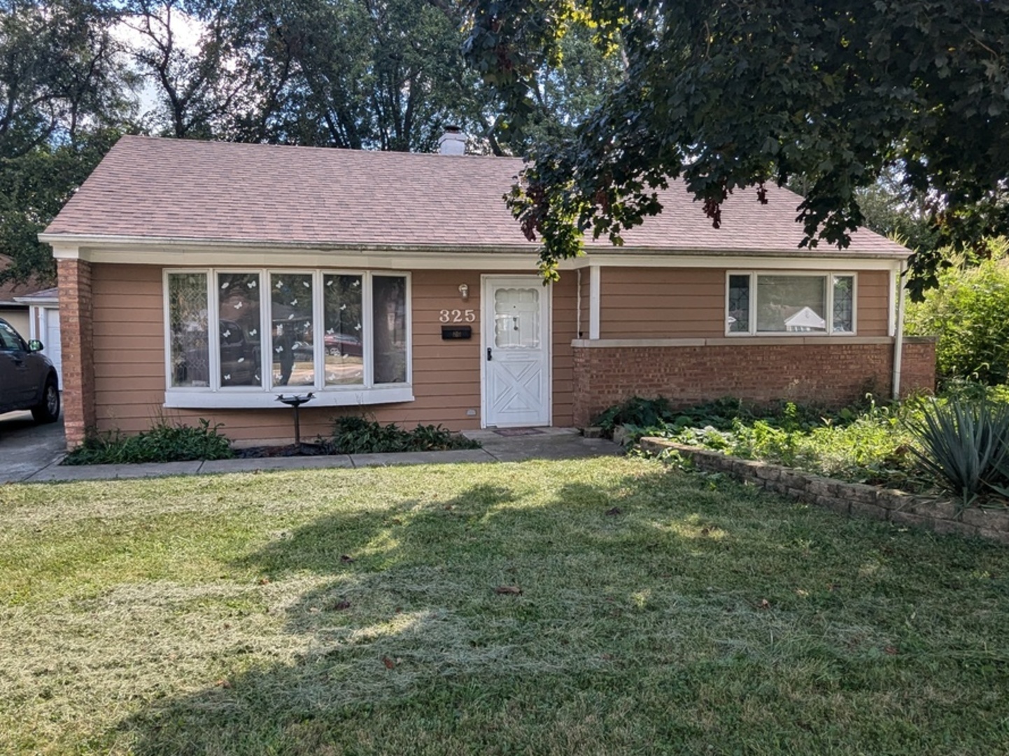 a front view of a house with a garden