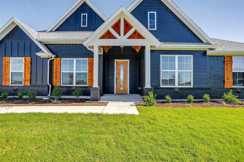 a front view of a house with swimming pool and porch