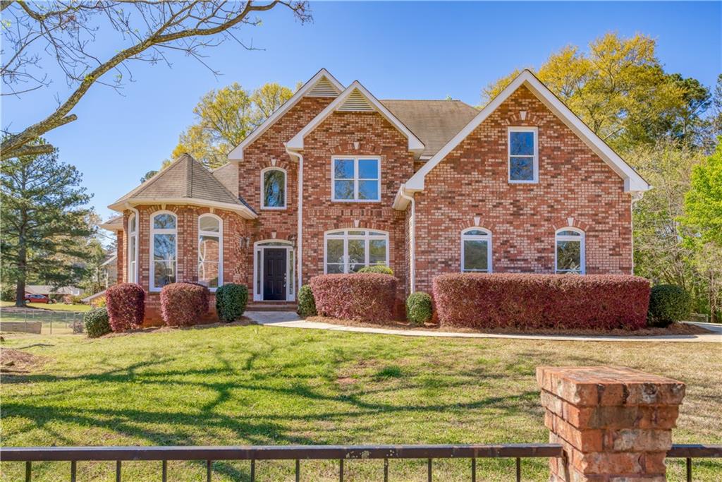 a front view of a house with a yard