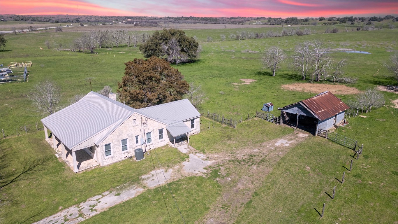 an aerial view of a house with a yard and a terrace