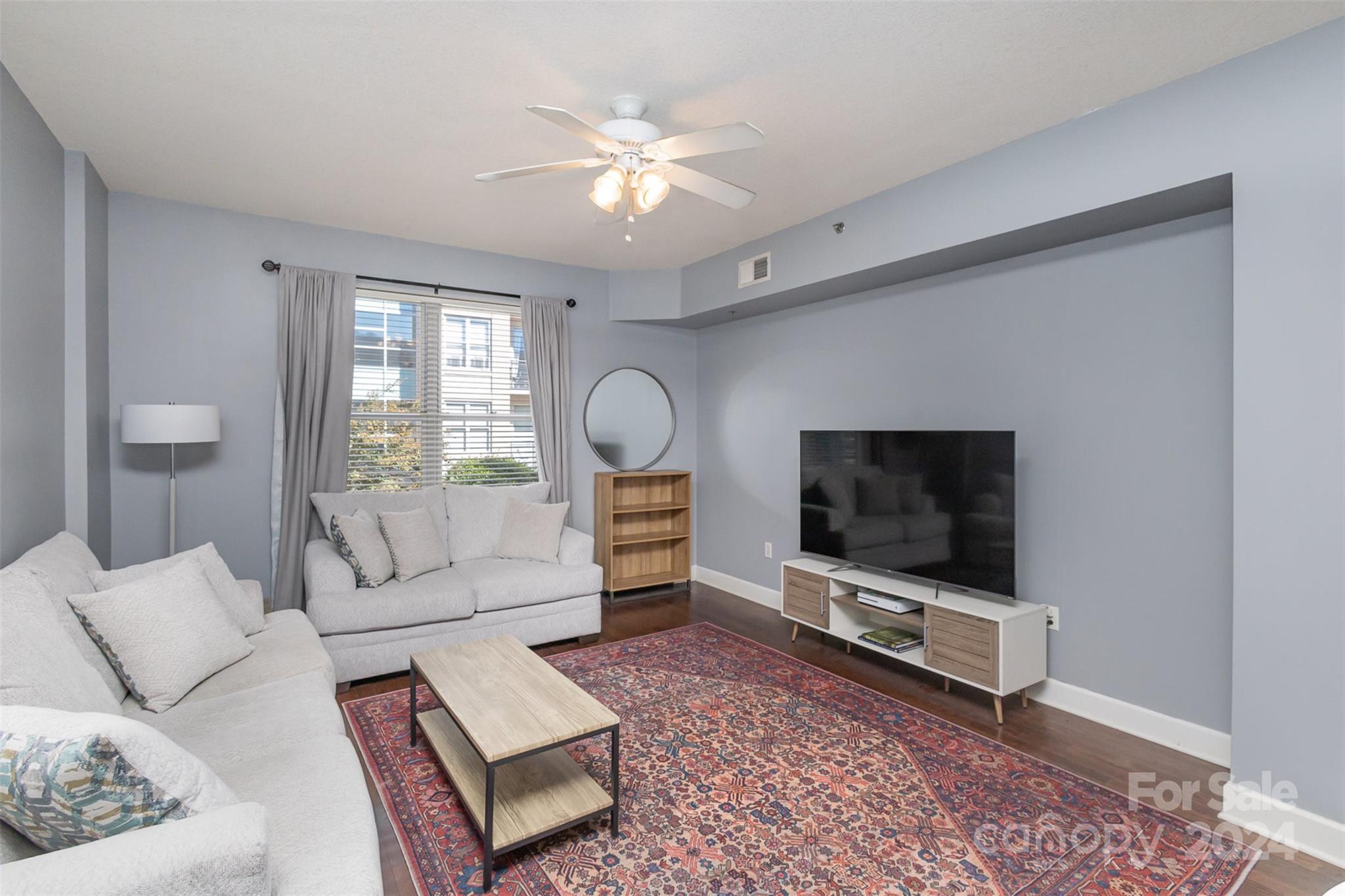 a living room with furniture and a flat screen tv