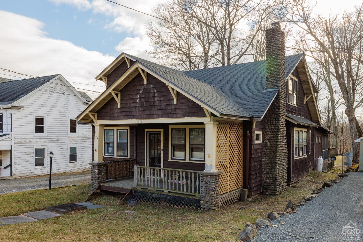 a view of a house with a yard and wooden fence