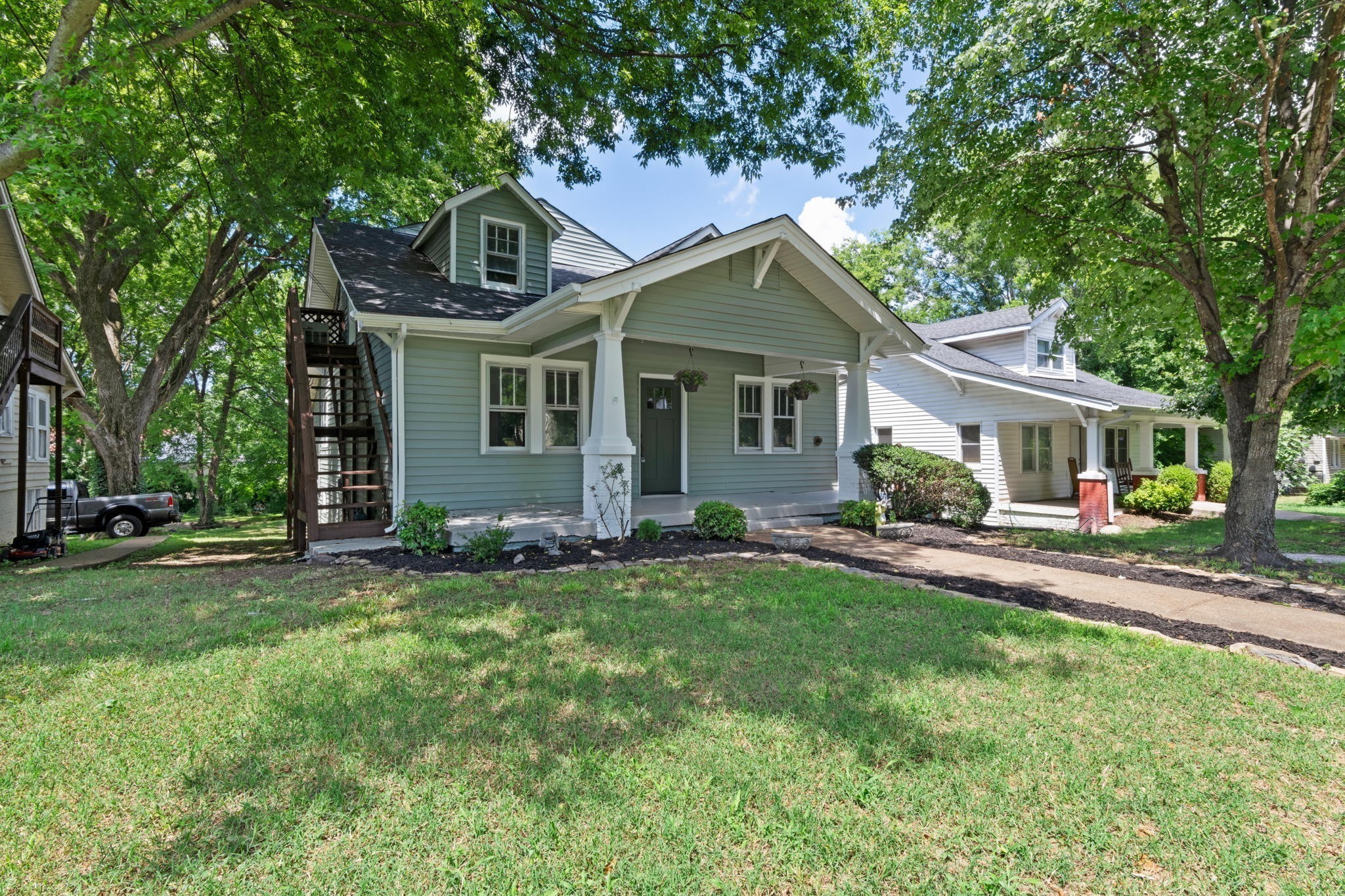 a front view of house with yard and green space