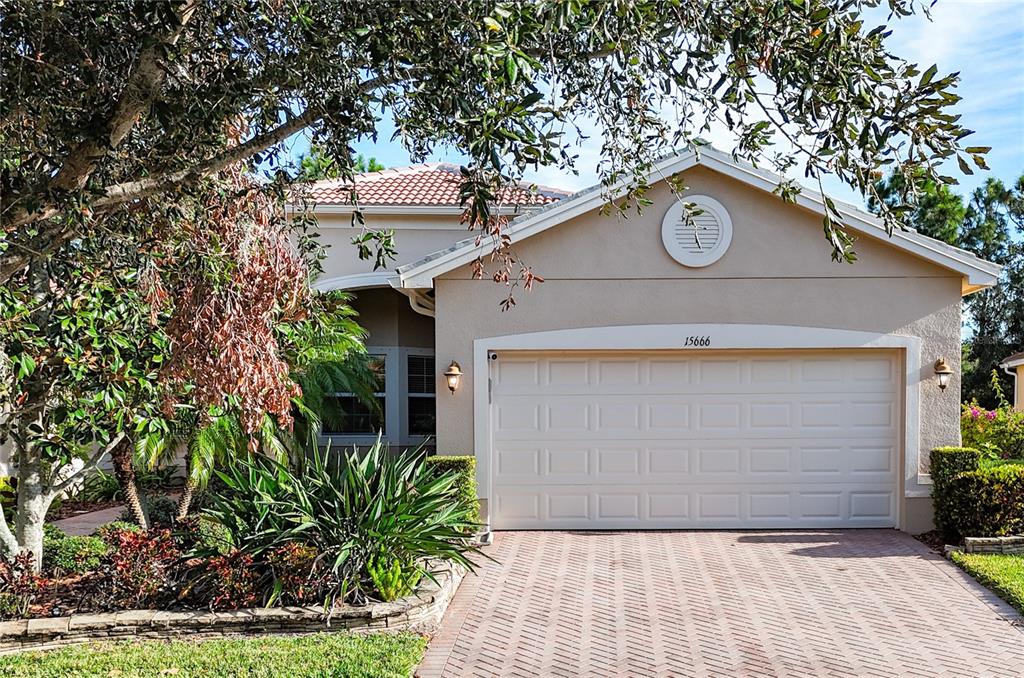 a view of a house with a garage and a yard