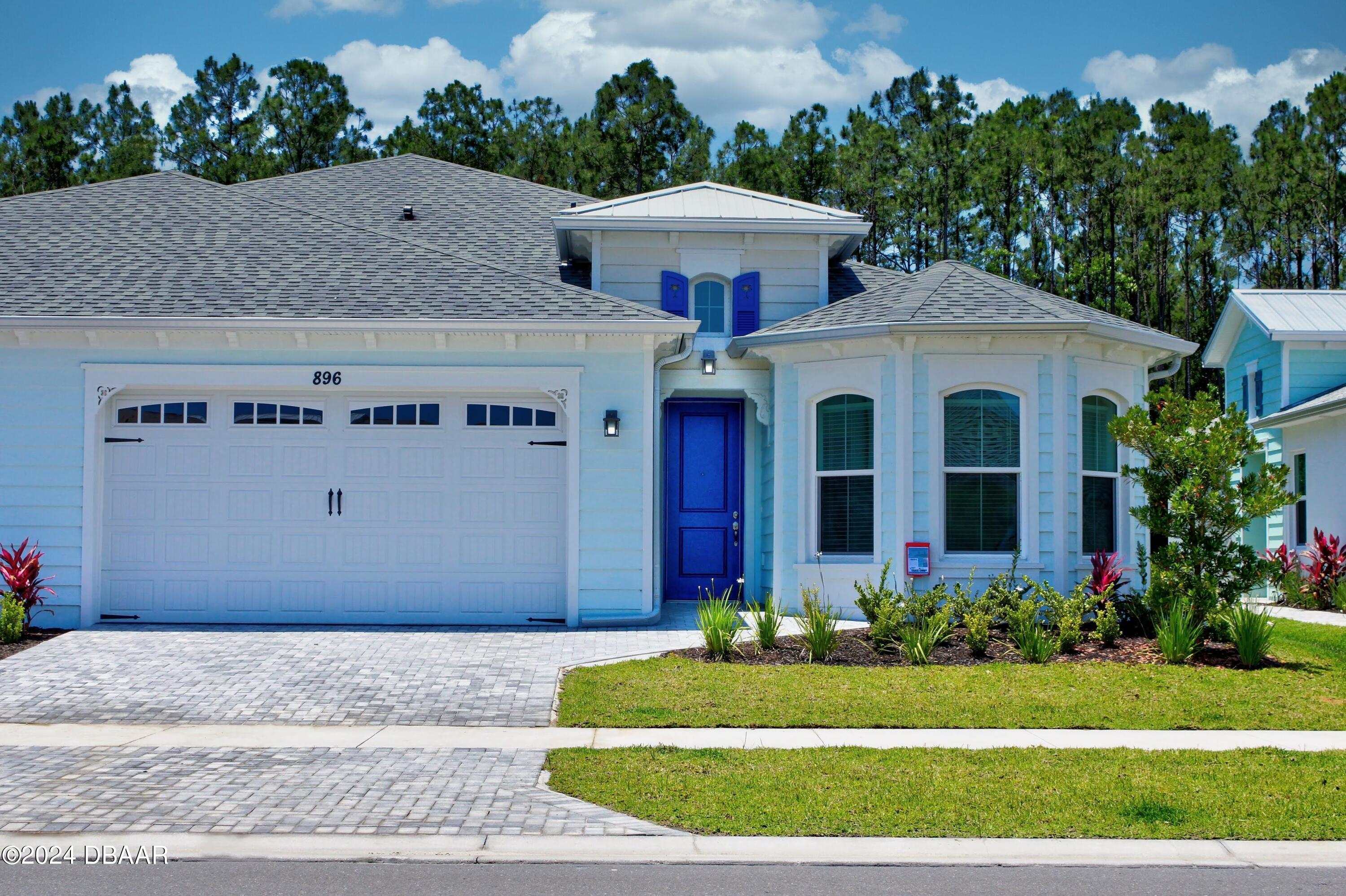 a front view of house with yard and green space