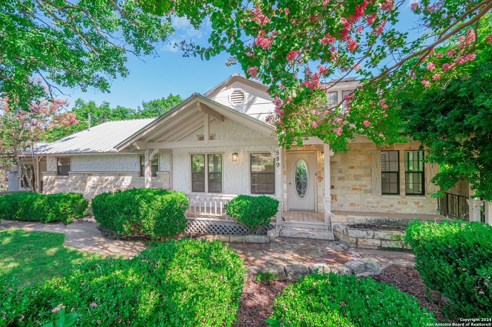 a front view of a house with garden