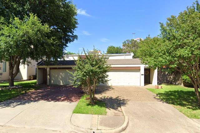 a front view of a house with a yard and a garage