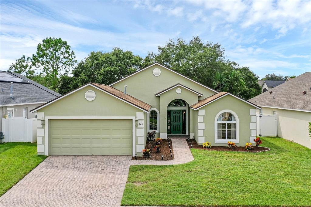 a front view of a house with a yard and garage