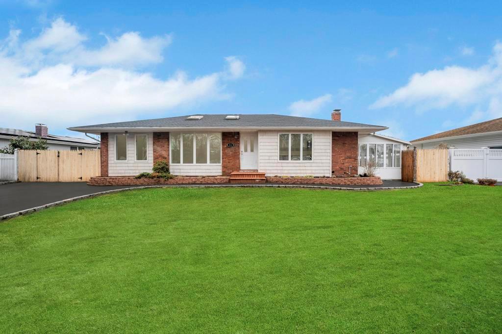 Single story home featuring a front lawn