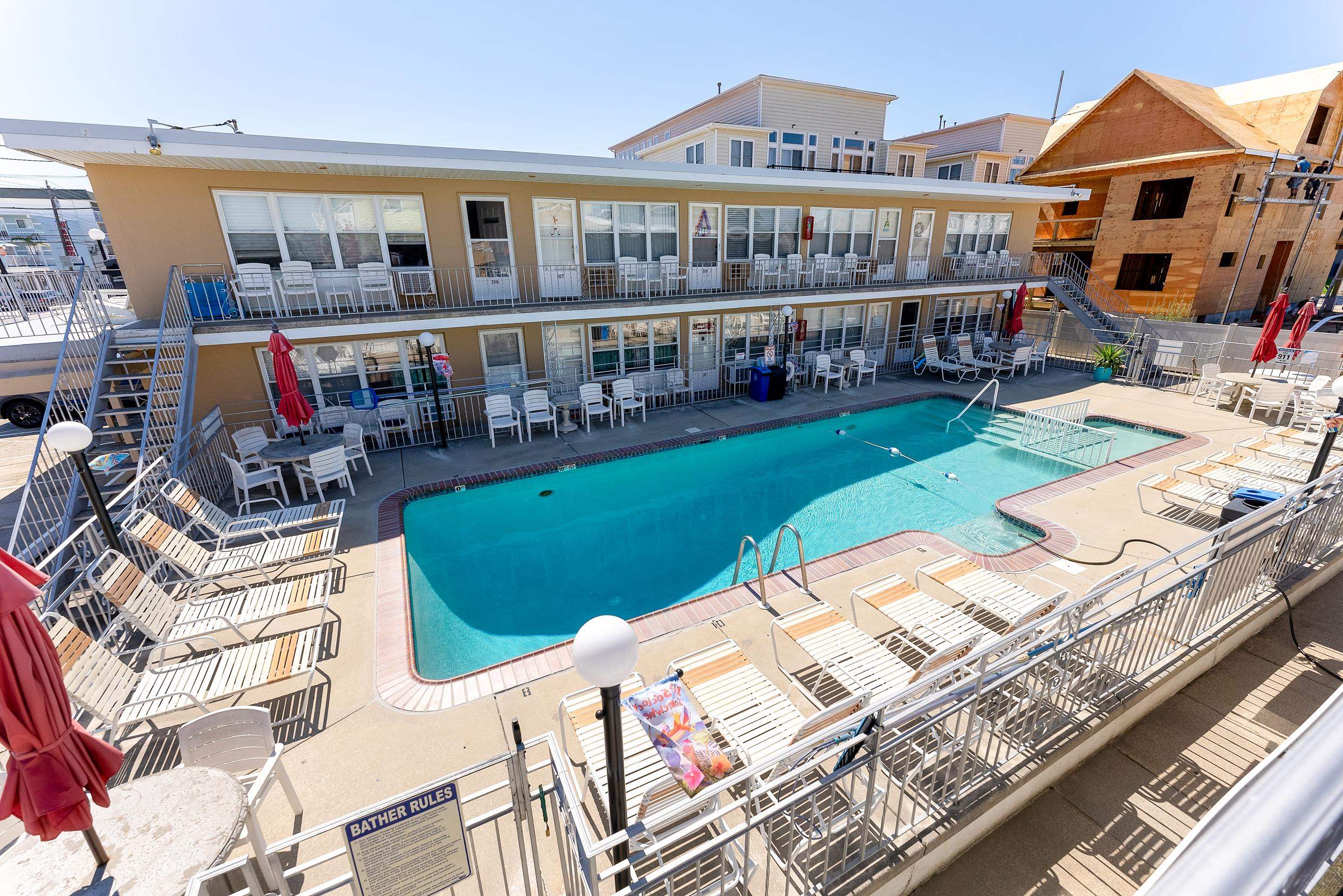 a view of a house with swimming pool and sitting area