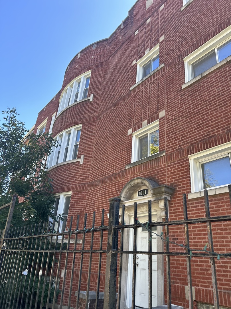 a front view of a residential apartment building with a yard