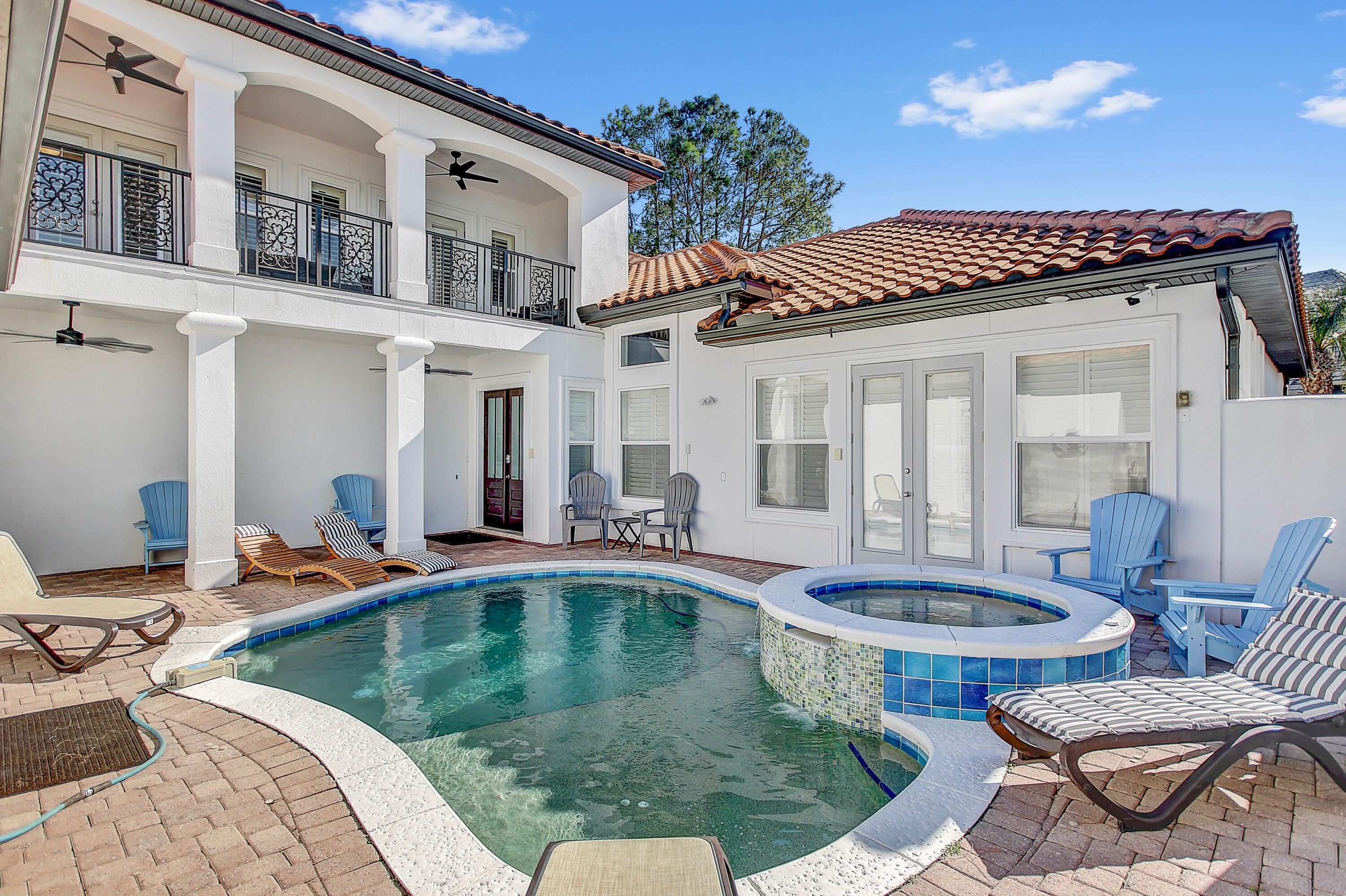 a swimming pool with outdoor seating and yard