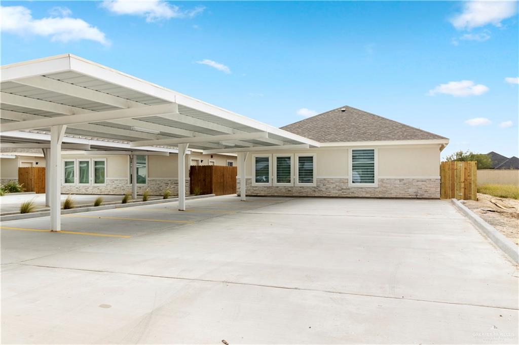 Back of property with a carport