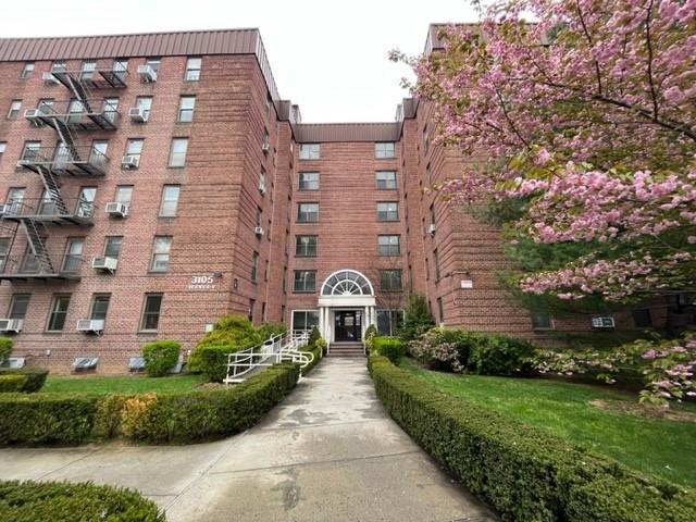 a front view of a building with garden